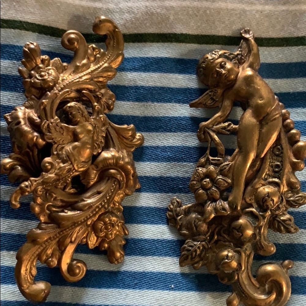 Victorian style cherub brooches and earrings .